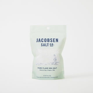 Jacobsen salt pure flake sea salt in light green container with navy blue text 