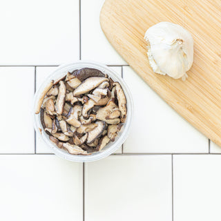 par roasted shiitake mushrooms in a reusable container