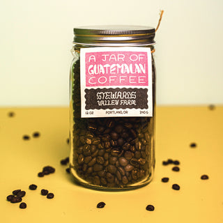 stewards valley farm coffee beans in a glass jar with coffee