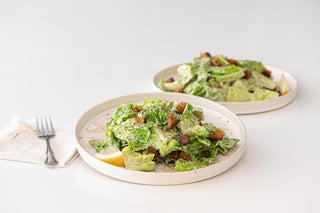 Two plates of Caesar Salad with pan fried sourdough croutons
