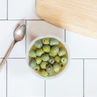 pitted castelvetrano olives in a reusable container