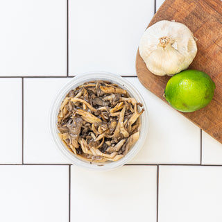 par-roasted oyster mushrooms in a reusable container